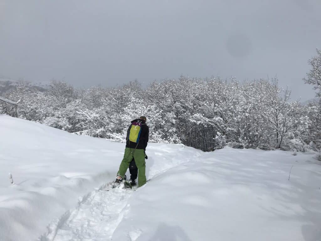 man snowshoeing with child