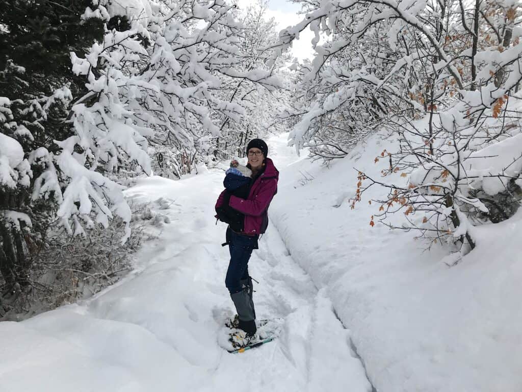 woman snowshoeing with baby